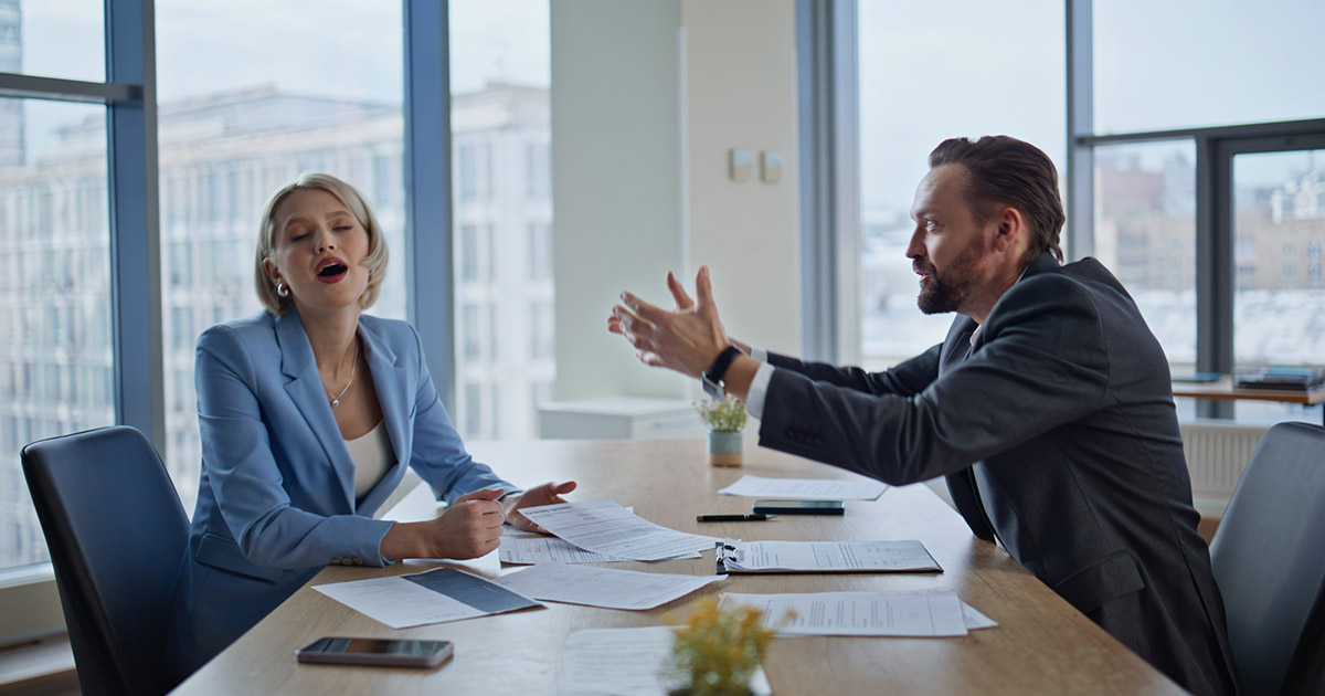 Business professionals in a tense meeting, gesturing and discussing documents in a modern office with large windows